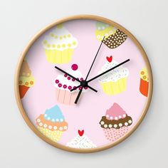 a pink clock with cupcakes and hearts on it