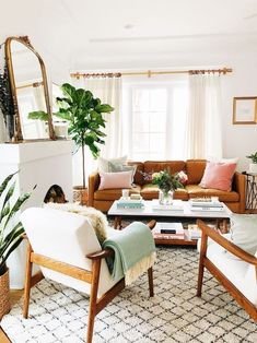 a living room filled with furniture and a fire place next to a mirror on the wall