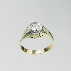 an old - fashioned diamond ring with filigrees is displayed on a white background