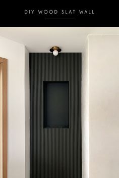 a black and white bathroom with the words diy wood slat wall above it