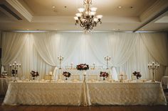 the table is set up with candles and flowers for an elegant wedding breakfast or reception