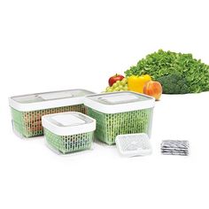 three plastic containers with lids and vegetables in the background