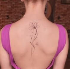 a woman with a flower tattoo on her back