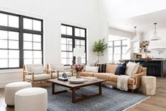 a living room filled with furniture and lots of windows