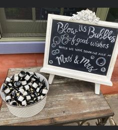 a sign that says blow us bubbles and say good wishes next to a bowl of mussels