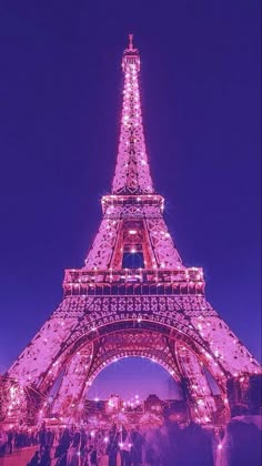 the eiffel tower is lit up at night