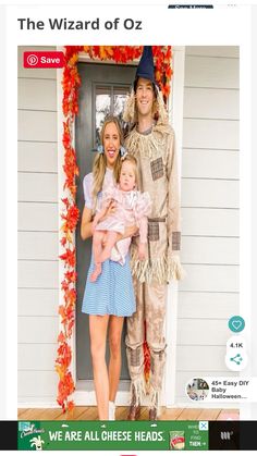 the wizard of oz costume is on display with two women and a baby in front of a door