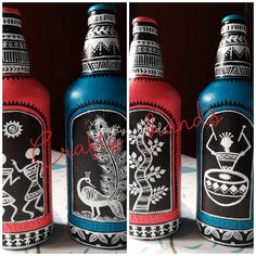 three bottles with designs painted on them sitting next to each other