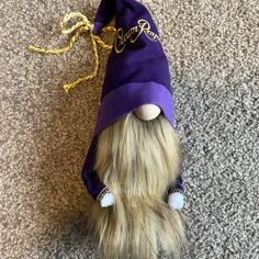 a stuffed animal with a purple hat on it's head is laying on the floor