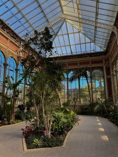 the inside of a building with lots of plants and trees in it's center