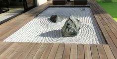 a rock garden in the middle of a wooden deck