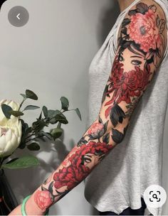 a woman with a flower tattoo on her arm