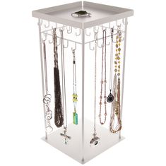 a white jewelry holder with multiple necklaces hanging from it's sides