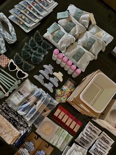 many items are laid out on the table to be used for sewing and other crafting projects