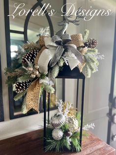 a christmas lantern with pine cones and evergreens on it