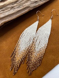 Native style earrings. They are made with the smallest size Miyuki beads so they are extremely light. The earring hooks are made of premium quality 316 stainless steel. They do not cause allergies since they are free of nickel and lead. If for any reason this product does not meet your expectations, return it within 7 days and we will refund your money. White Beaded Long Drop Earrings, White Long Drop Earrings With Dangling Beads, White Long Drop Jewelry With Beaded Fringe, White Long Drop Chandelier Earrings With Dangling Beads, White Fringe Beaded Dangle Earrings, White Beaded Fringe Dangle Jewelry, White Round Beaded Tassel Jewelry, White Beaded Fringe Long Drop Earrings, White Fringe Tassel Drop Earrings