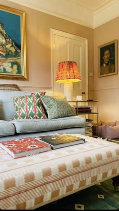 a living room filled with furniture and pictures on the wall above it's coffee table