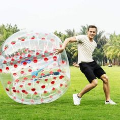 a man is playing with an inflatable ball