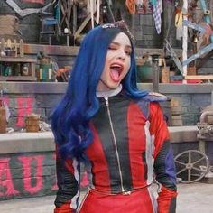 a woman with blue hair wearing a red and black outfit