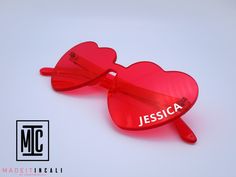 This listing is for ONE pair of personalized Heart shaped tinted glasses. xx Customize with your own text to make these an easy but fun gift for all kinds of occasions! xx Your text will be added in your choice of White or Black vinyl xx Non-Polarized xx Color: Rose Red xx One size fits most xx Dimensions:  Front Width: approx 5.6 inches Temple Length: approx 5.5 inches xx Material: Plastic Please message if you have questions! Valentine's Day Gift Sunglasses With Tinted Lenses, Fun Sunglasses As Valentine's Day Gift, Fun Sunglasses For Valentine's Day Gift, Heart-shaped Sunglasses With Tinted Lenses As Gift, Heart-shaped Sunglasses With Tinted Lenses For Gift, Heart-shaped Sunglasses For Valentine's Day Gift, White Heart-shaped Sunglasses For Valentine's Day, Heart-shaped Pink Sunglasses For Gift, Rose Colored Sunglasses