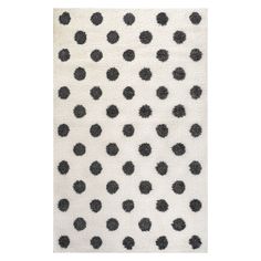 a white rug with black dots on it