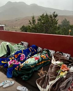 blankets and slippers are laid out on the ground