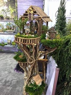 a tree house made out of branches and plants