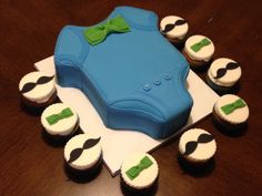 cupcakes are arranged in the shape of a briefcase with green bow ties on it