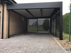 an open garage door on the side of a brick building