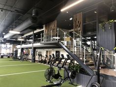 an indoor gym with treadmills, exercise bikes and other personal training equipment in it