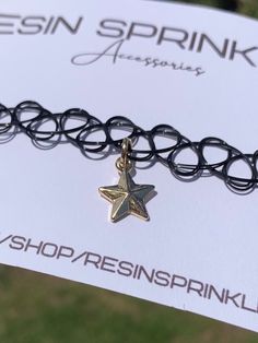 One size fits all black elastic tattoo choker necklace with a dainty nickel-free gold enamel star charm ✨ Star is approximately 1cm x 1cm  Thanks for visiting my shop! ⭐️ Star Charm Choker Necklace For Gifts, Trendy Star Charm Choker, Black Star Charm Jewelry, Trendy Adjustable Star Charm Necklace, Adjustable Trendy Star Charm Necklace, Star-shaped Metal Choker As Gift, Star-shaped Metal Choker For Gift, Trendy Star Charm Choker As Gift, Trendy Choker With Star Charm For Gift