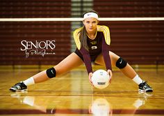 a female volleyball player is posing for a photo on the court with her racket and ball