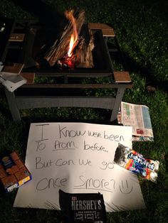 a sign sitting on the ground next to a fire