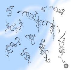 an artistic set of swirls and scrolls on a blue sky with clouds in the background