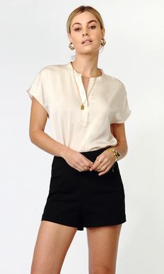 Designed in a cream, satin fabric. Short-sleeve blouse with a button front detail. The essential for building an outfit or wearing as a basic. Layer and pair with a diverse variation of pants and jackets. Satin top Short sleeve Button front Self: 95% Polyester, 5% Spandex Length: 24" Chest: 20 1/4" Hand wash in cold wa Tailored Shorts, Luxury Women Fashion, Satin Top, Casual Tee, Short Sleeve Blouse, High Waisted Shorts, Satin Fabric, Modern Woman, Suits For Women