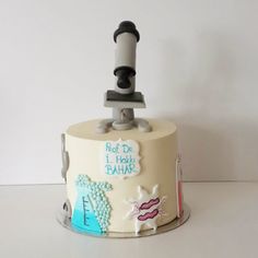 a cake that has been decorated to look like a microscope and some writing on it