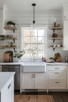 a kitchen with white cabinets and open shelves