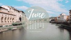 a calendar with the word june on it in front of a river and some buildings