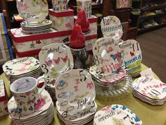 there are many plates and cups on display at the store, including one for each child