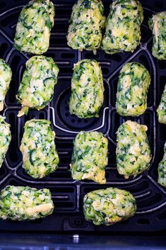 broccoli balls being cooked in an air fryer with cheese and spinach