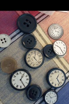 there are many different clocks on the table and one is black, white and grey