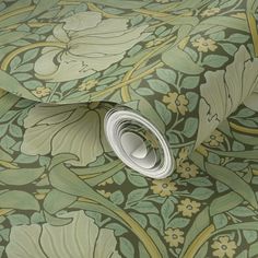 a wallpaper with green and yellow floral designs on the bottom, along with a rolled up roll of paper