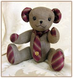 a brown teddy bear wearing a tie and sitting on a white background with a gold star