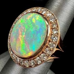 an opal and diamond ring is shown