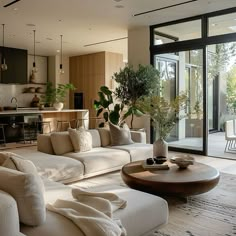 a living room filled with furniture and a large glass door leading to an outside patio