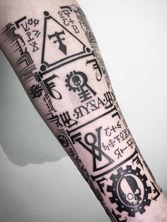 a man's arm with various symbols on it