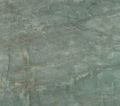 a green marble textured surface with lines and dots