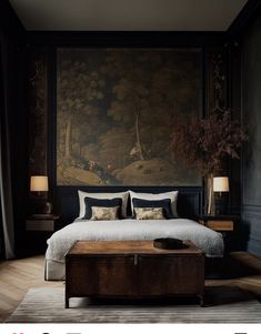 a bedroom with a large painting on the wall above it and a wooden coffee table