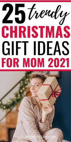 a woman sitting on the floor holding a present box with text overlay that reads 25 friendly christmas gift ideas for mom 2021