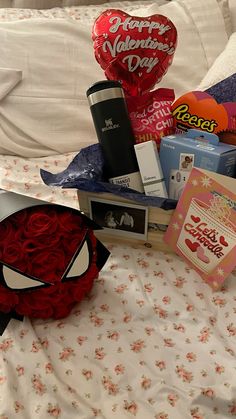 valentine's day gifts laid out on a bed